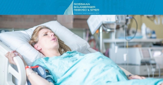 Pregnant woman in hospital bed breathing